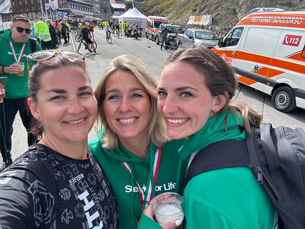 Three colleagues posing in front of the camera during Stelvio for Life